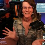 A YouTube thumbnail style image of a white woman looking happy and excited. On the left is a smaller version of her in more casual clothes with small text reading: “There is no "editing Phenn"  "Editing Phenn" is a figment of our collective imaginations ” In the top left corner that is additional text reading YouTube and Twitch @Phennoflore and Bluesky @phenn.gay On her right is a text box reading: Muttday #29 At Least 3 Pawtism Jokes + all the fascism, Ai, Tech, and gaming news you love to hear twisted beyond recognition by something approaching wit “ over images of the gamecube game goblin commander and current fbi director kash patel in his christmas camo punisher hoodie